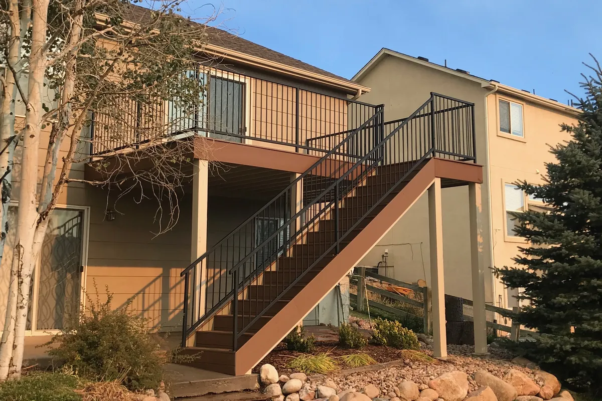 The rebuilt deck and stair, with composite decking and black steel railing