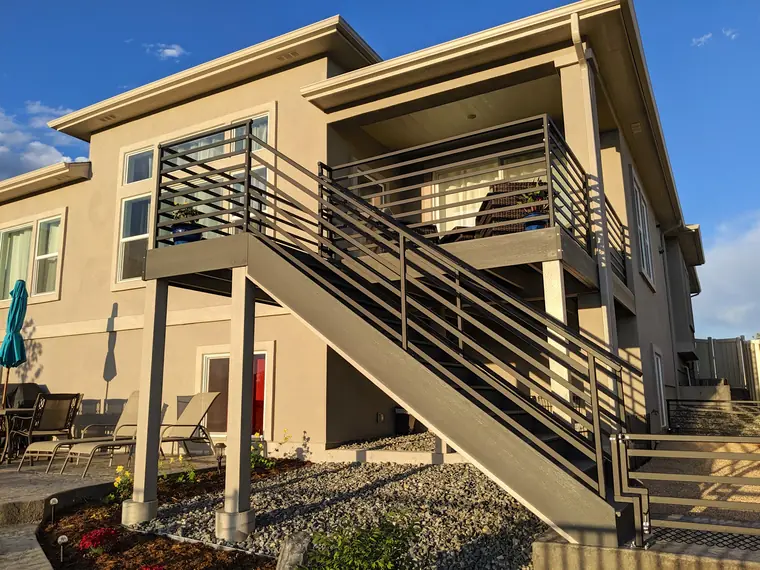 Modern horizontal railing around a raised deck and its full stair run